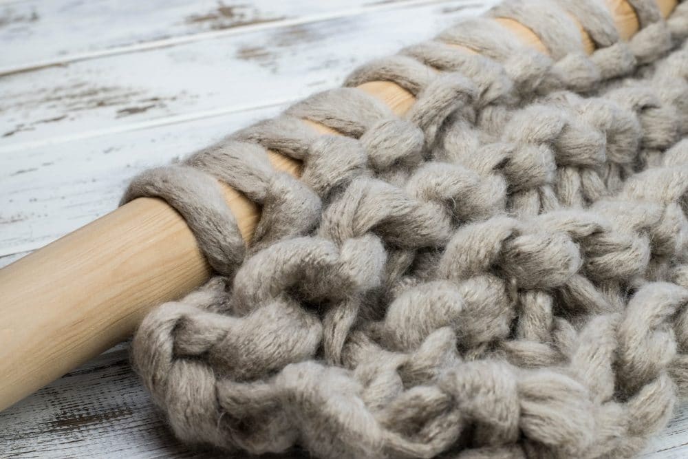 Close up of single jumbo yarn knitted on 55mm knitting needles.