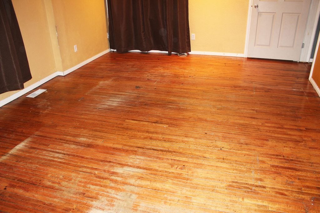 Damaged oak floors before restoration.