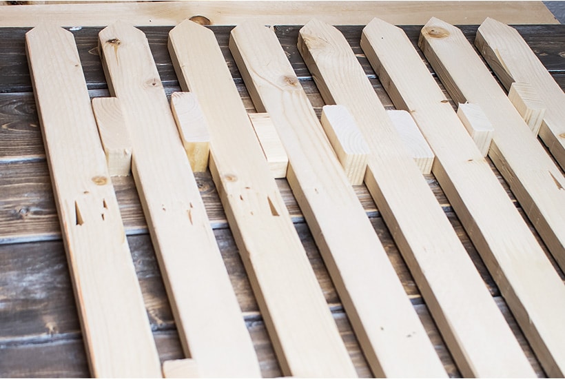 Pickets laid out with wood spacers between them.