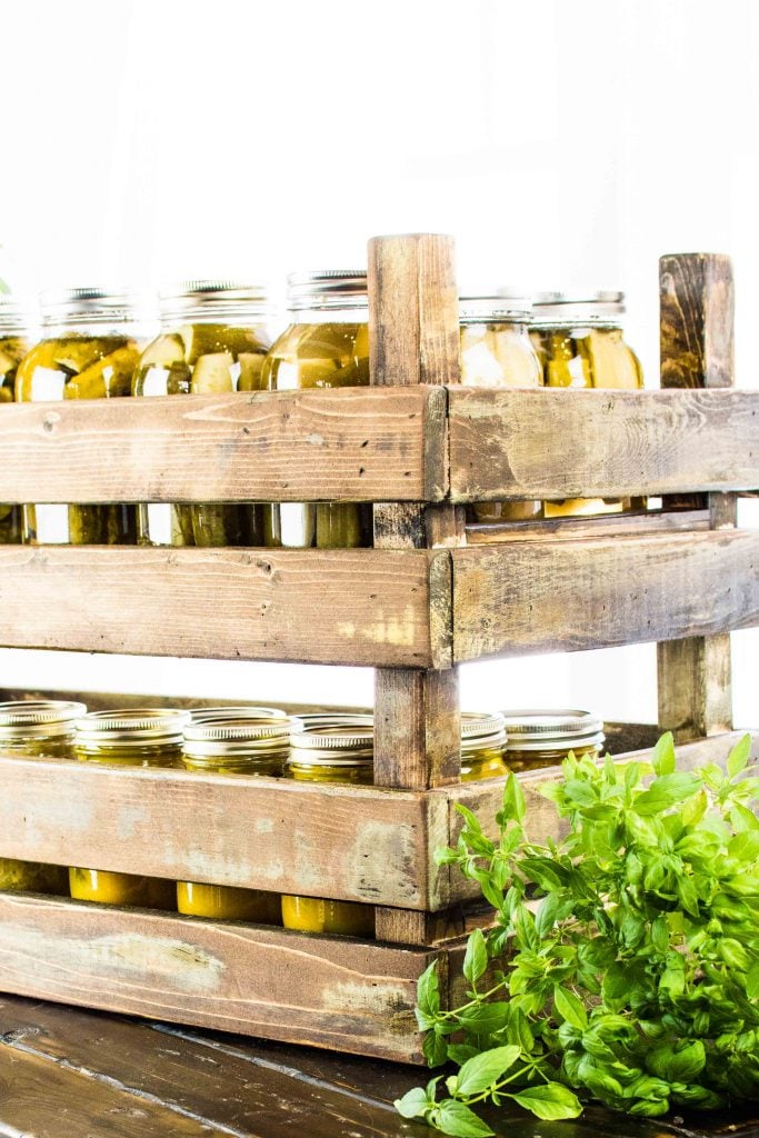 Rustic stackable storage bins filled with homemade pickles in mason jars