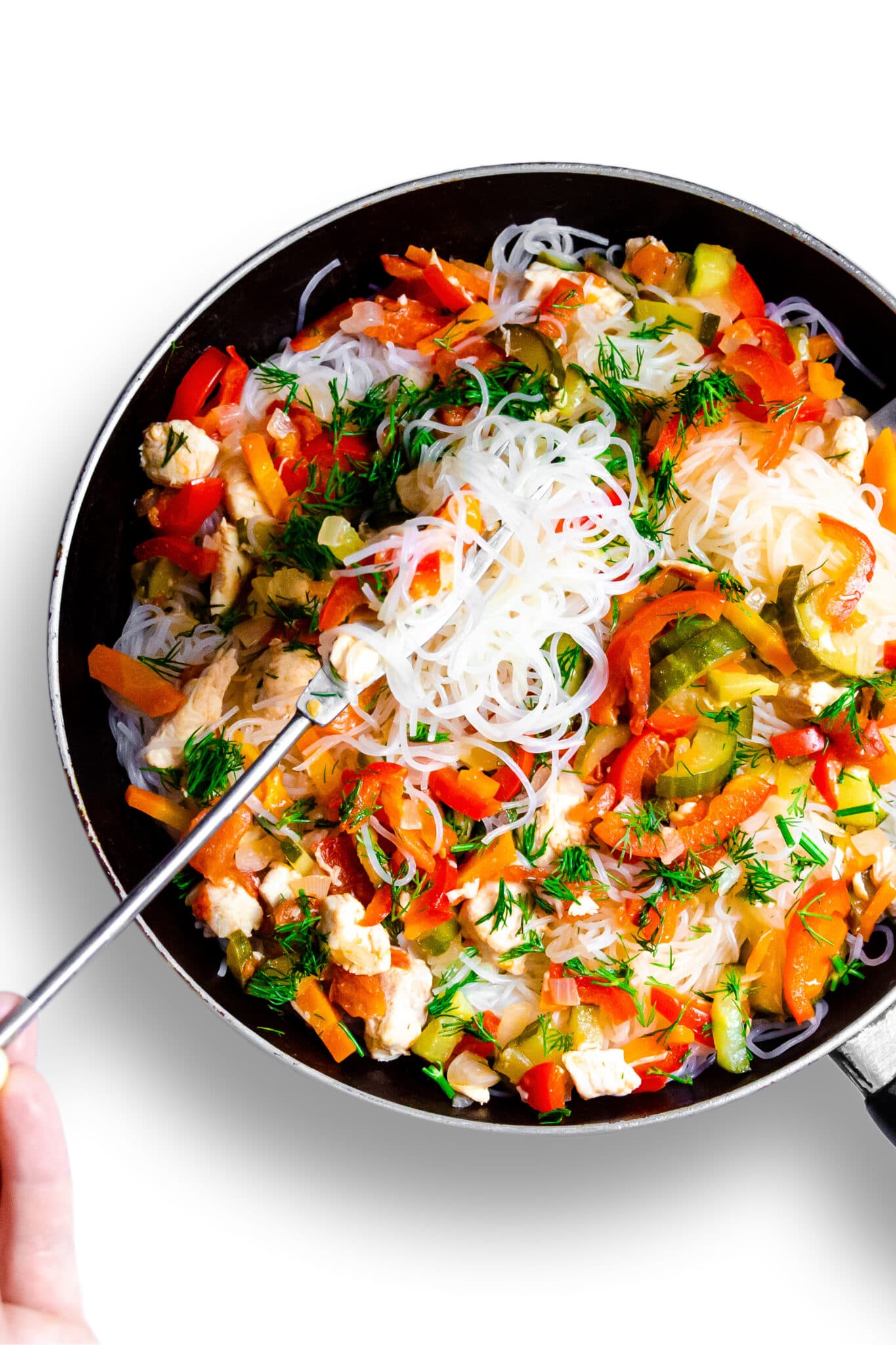 A stir fry in a pan with added cucumbers.