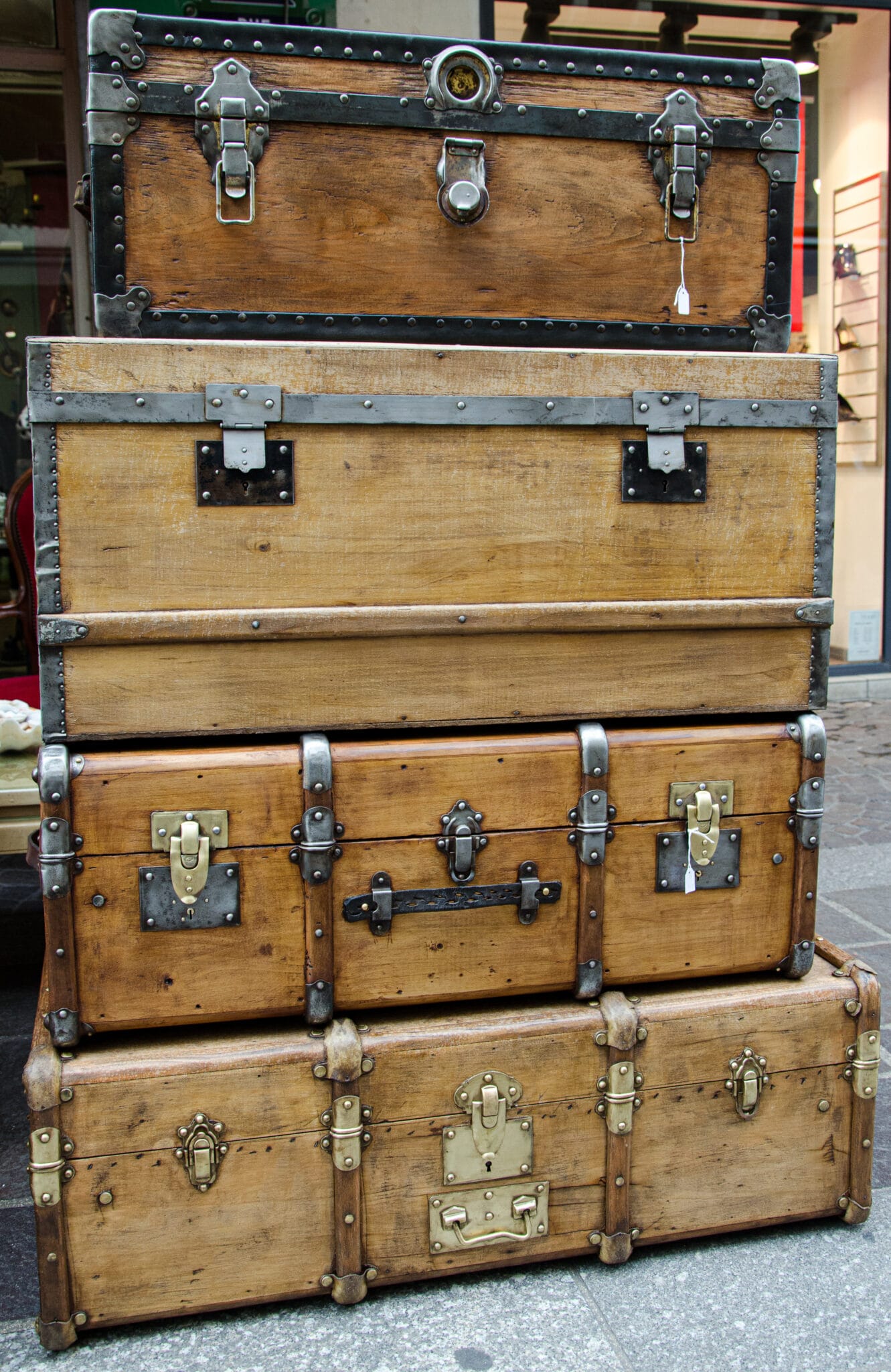 A stack of antique wooden trunks.