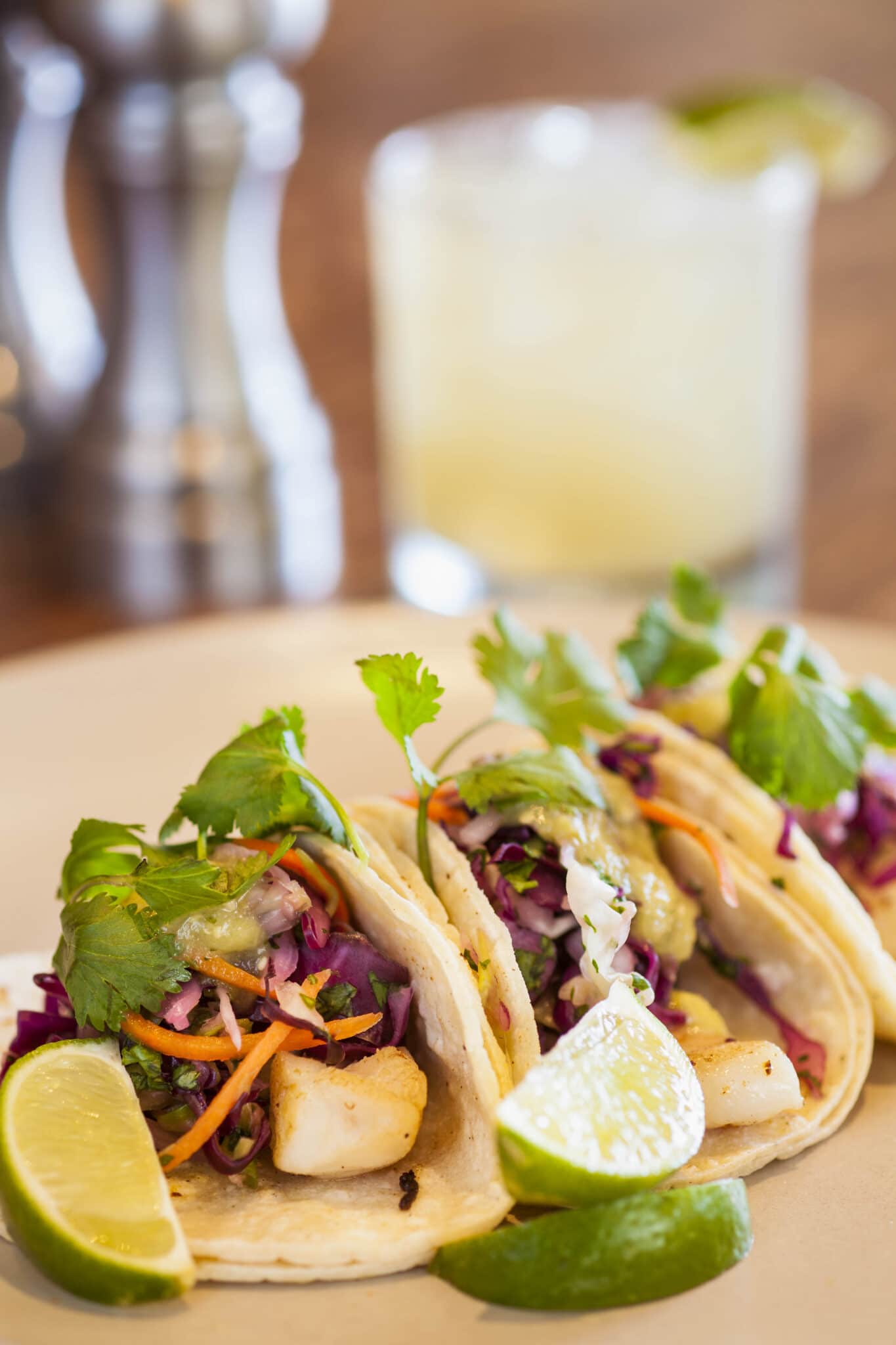 Fresh tacos with sprigs of cilantro.