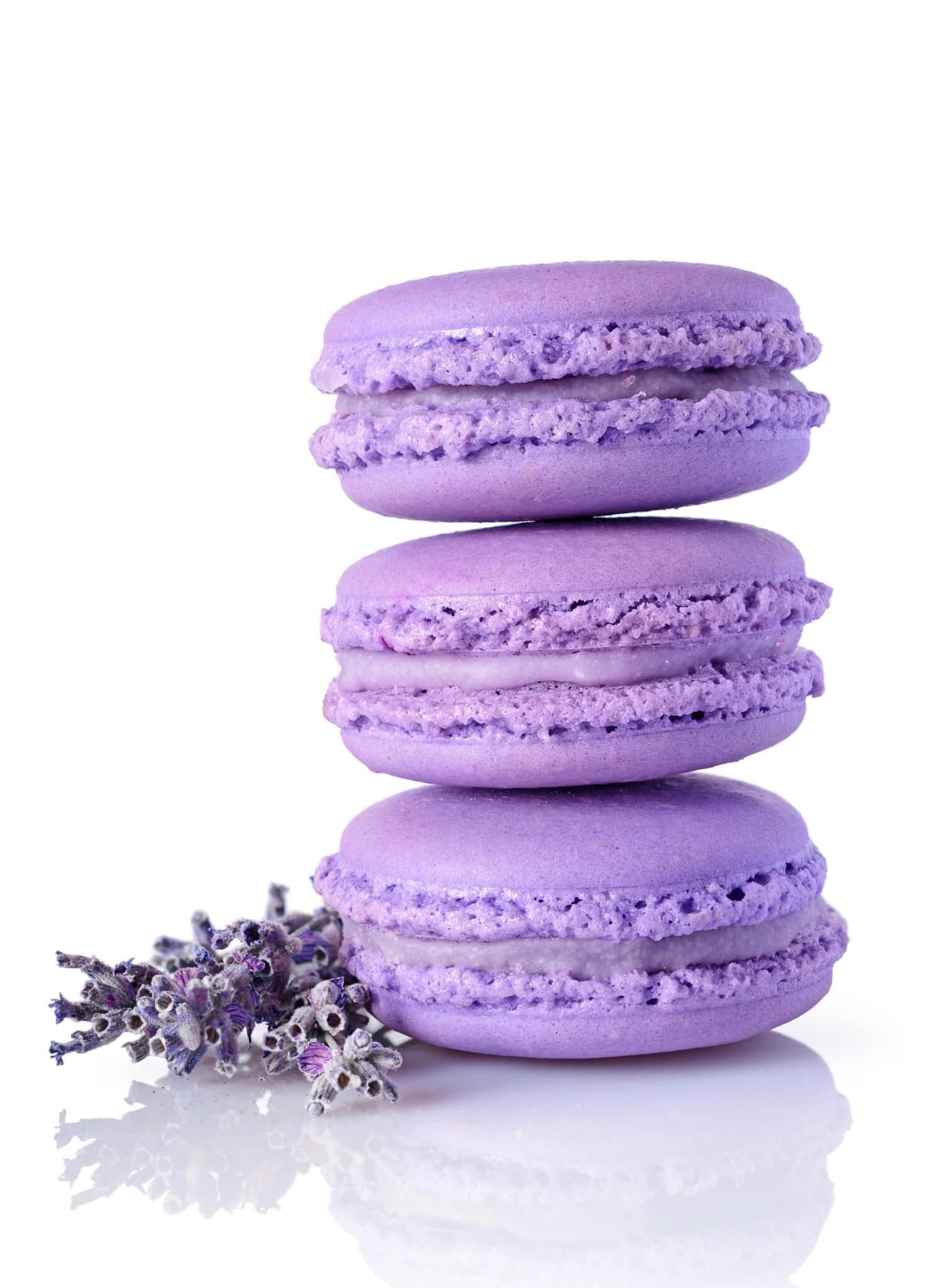 Lavender macaroons stacked 3 high against a bright white background.