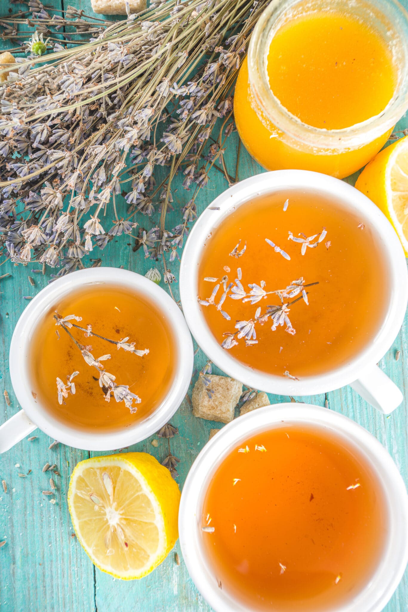 Aromatic lavender tea cup, with and bunch of lavender, honey and lemon, turquoise wooden background.