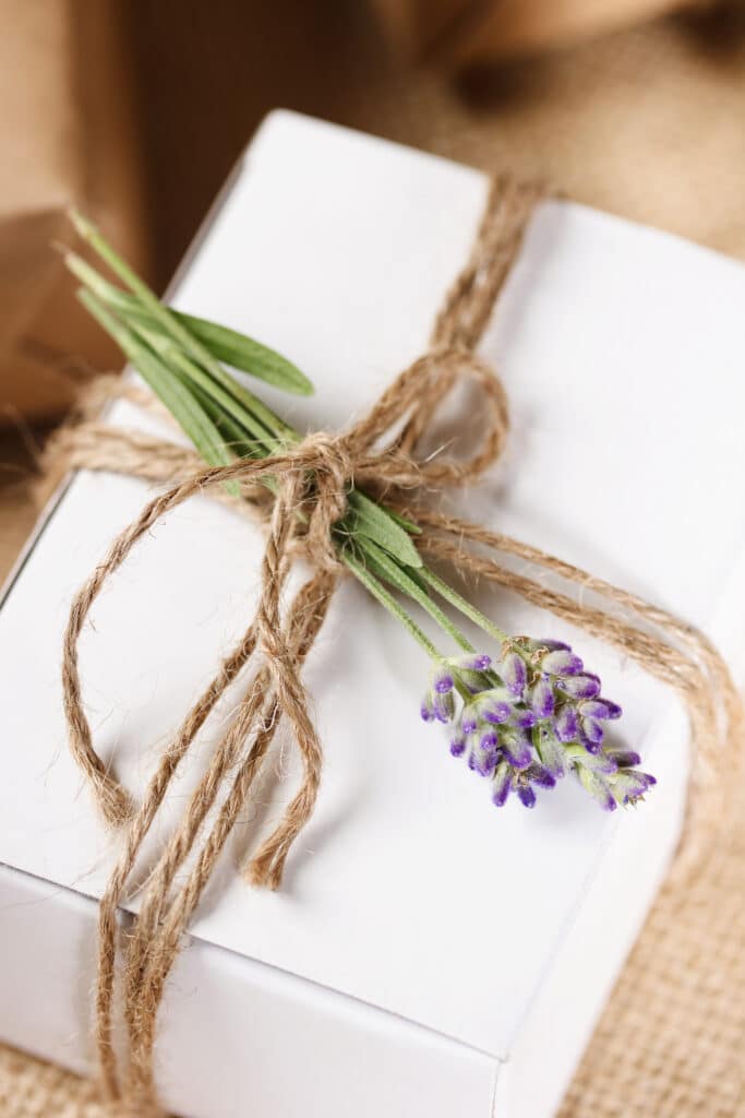 White Present box with rustic twine and sprig of lavender.