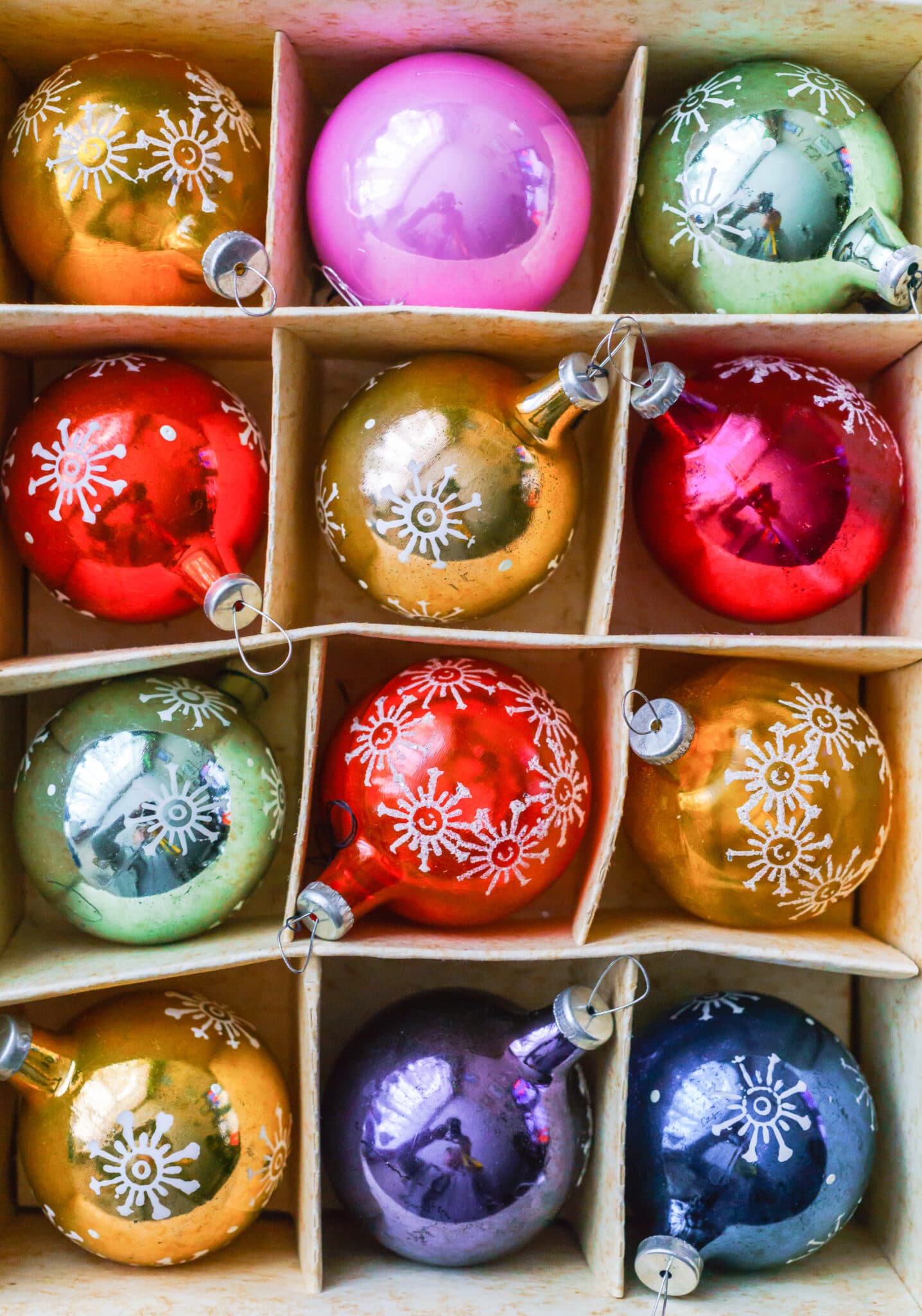 Set of 12 Luxury Winterberry Glass Baubles. Retro styled image of vintage Christmas decoration in a box. Christmas holidays composition. Box filled with christmas multi-colored baubles.