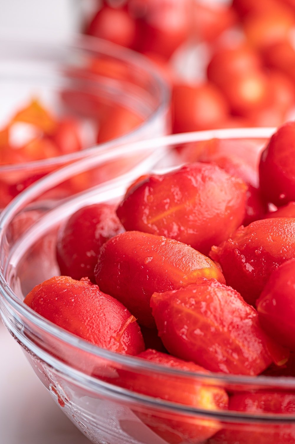 A bowl of peeled roma tomatoes ready for canning.