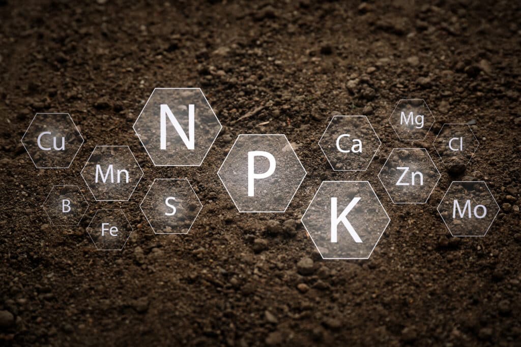 Texture of soil and its specified elemental components in hexagonal shapes overlaid on the soil.