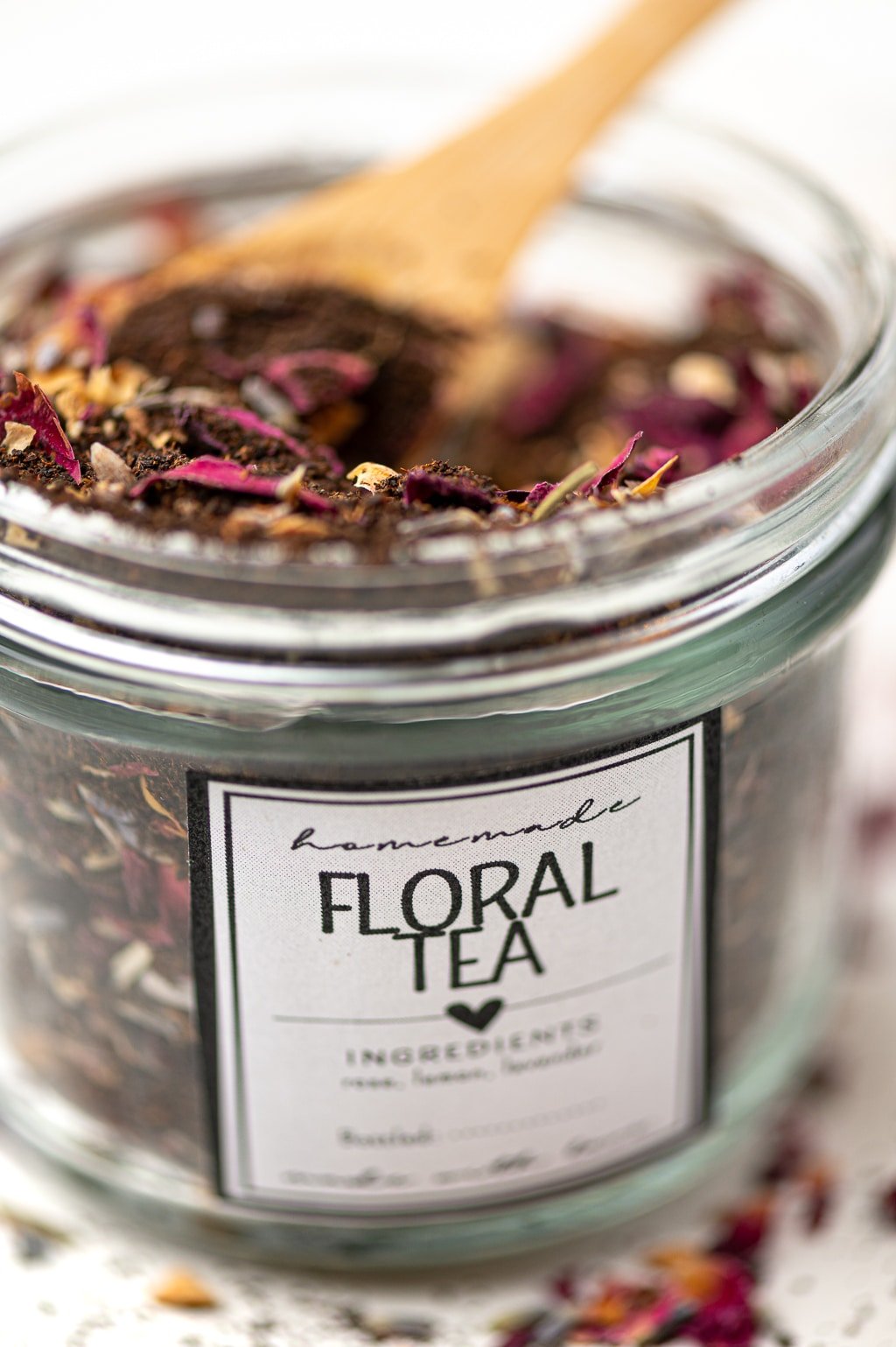 An upclose picture of a tea jar filled and labeled with a homemade floral tea blend.