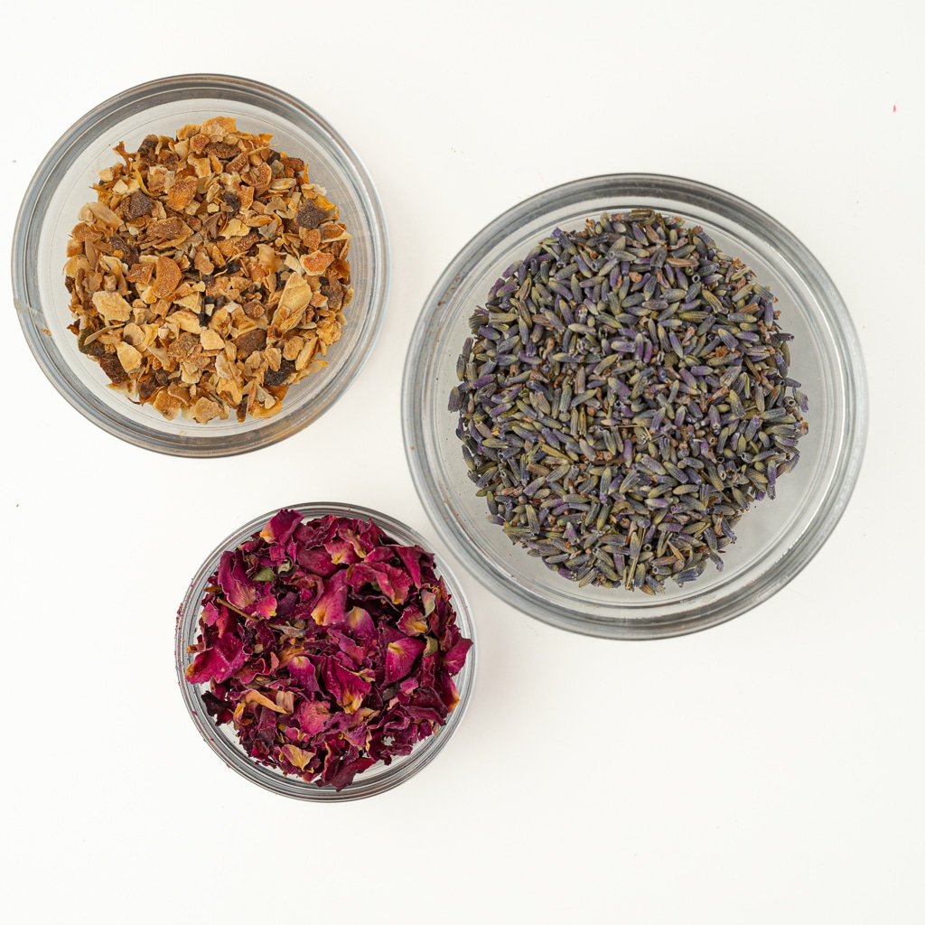 An image with our first tea blend combination with small glass bowls filled with lavender, lemon rind and rose petals.